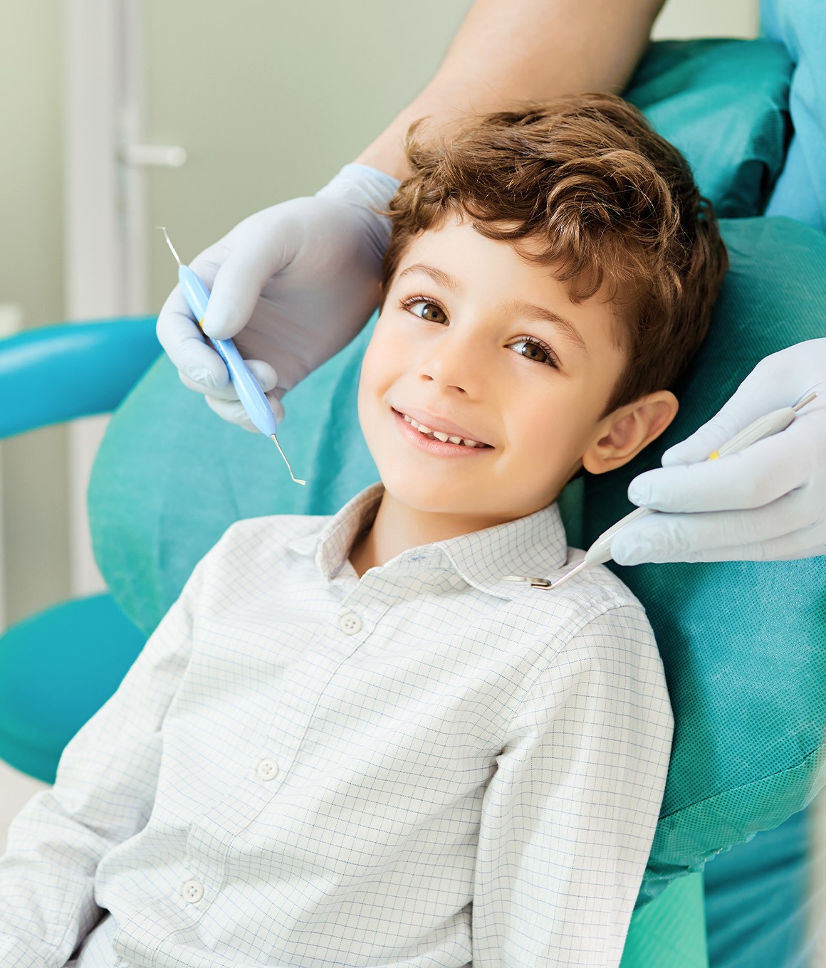 a young boy smiling during a dental visit