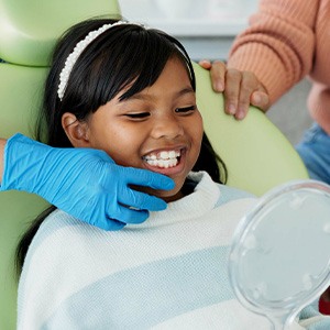 a child smiling during a dental appointment