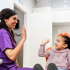 a child smiling during a dental appointment