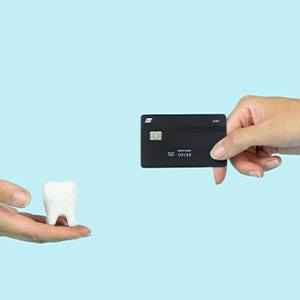 a person paying for a tooth extraction with a credit card