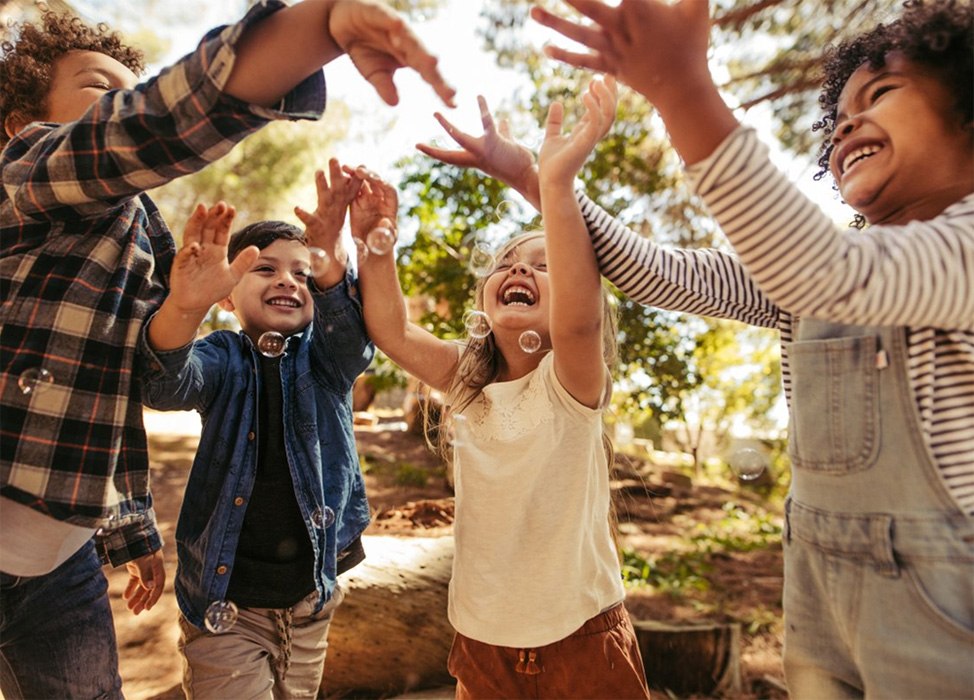 Smiling kids with families at park