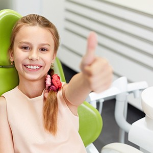 a child smiling during a dental checkup