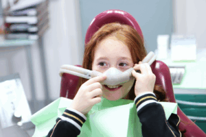 a young child at the dentist receiving sedation