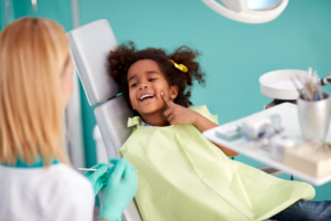 a dental assistant and a child patient 