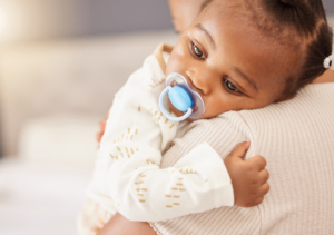 an infant with a pacifier