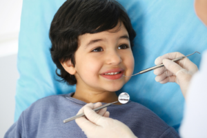 a child smiling during a dental checkup