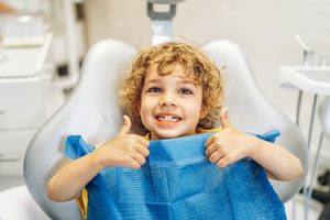 a child smiling during a dental appointment